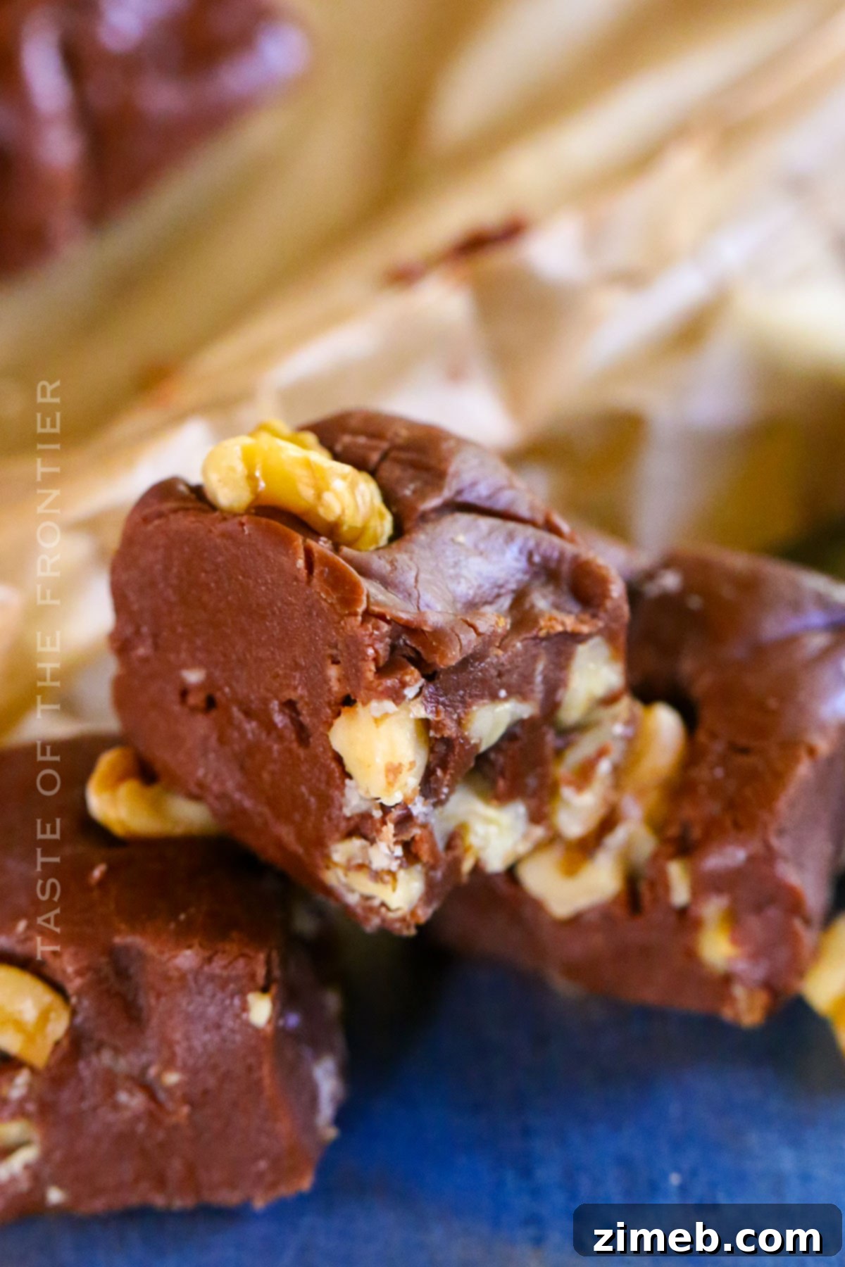 Surprisingly Delicious Velveeta Fudge 3 Delicious and easy Velveeta Fudge squares cooling on parchment paper, ready to be served for a special occasion or holiday.
