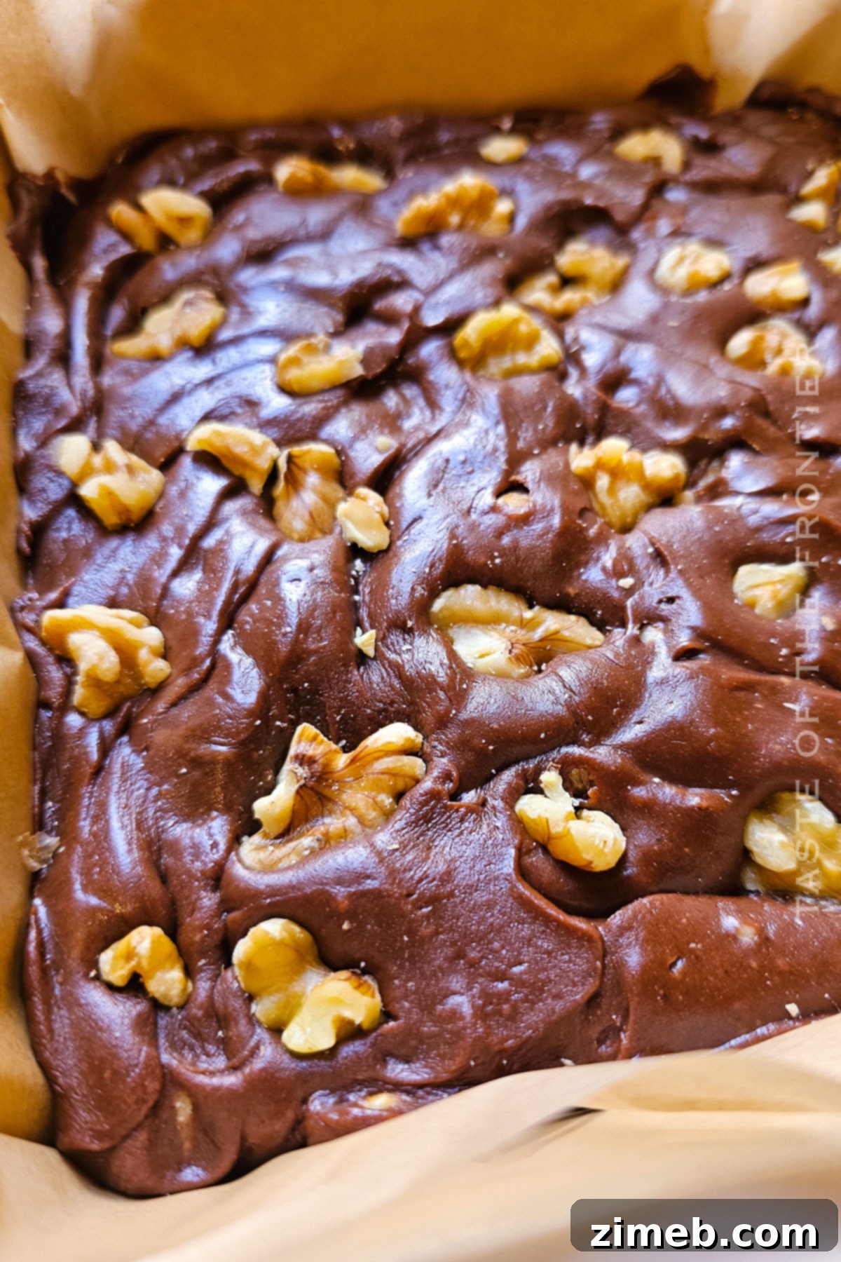 Surprisingly Delicious Velveeta Fudge 7 Close-up of a perfectly cut square of Velveeta Fudge with walnuts on a festive plate, ready for serving.