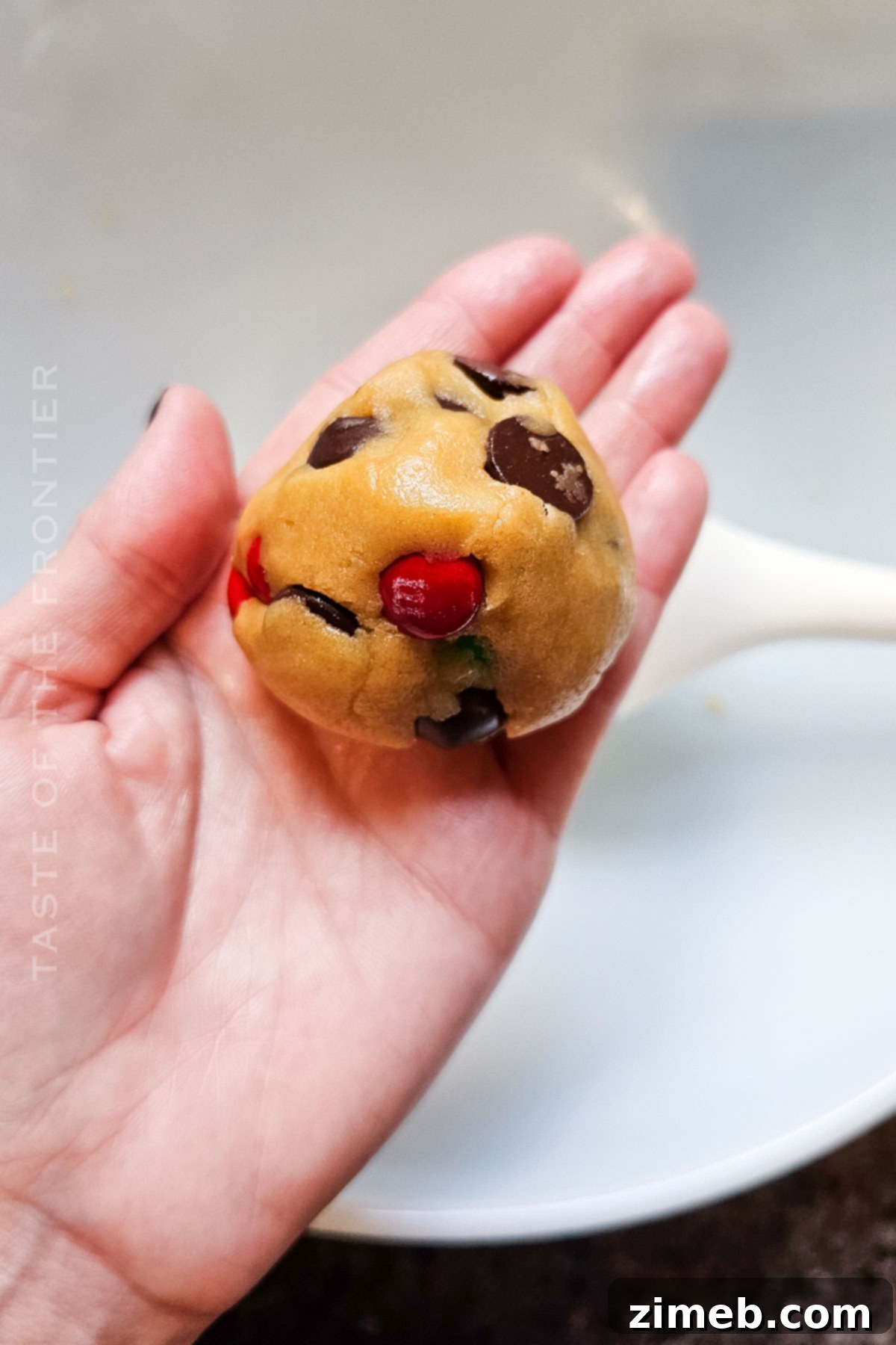 Portioned cookie dough balls on a baking sheet, ready for the oven