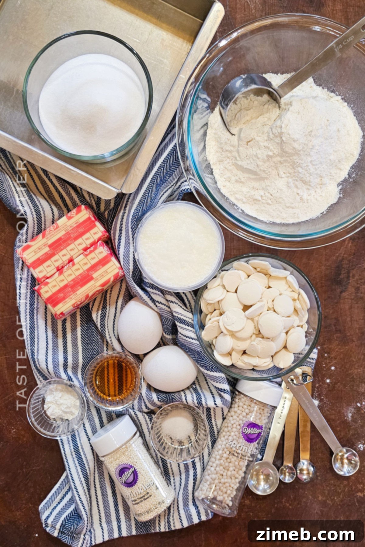 A flat lay of all the essential ingredients laid out for making a delicious White Chocolate Cake.
