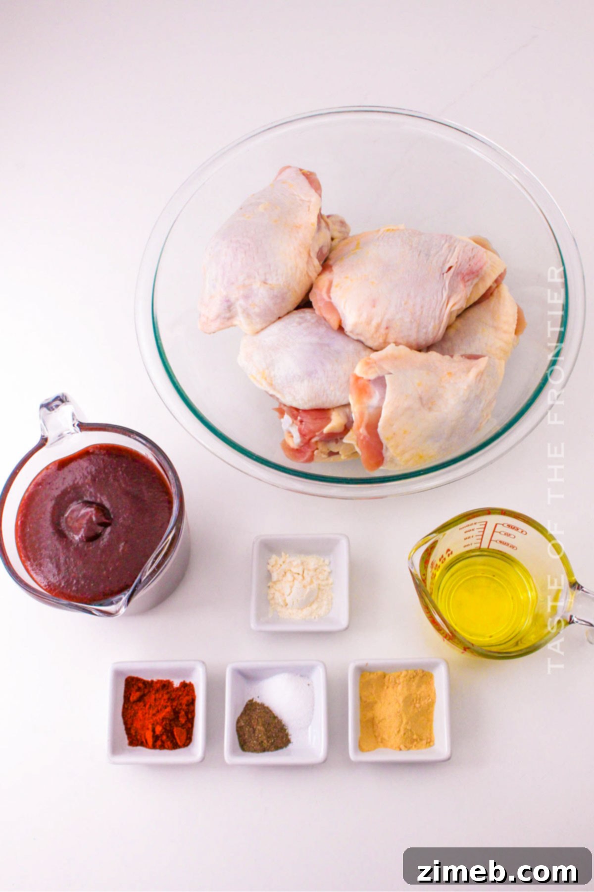 Oven Baked BBQ Chicken Thighs 4 Ingredients for Oven Chicken Thighs BBQ, laid out on a cutting board, ready for preparation.