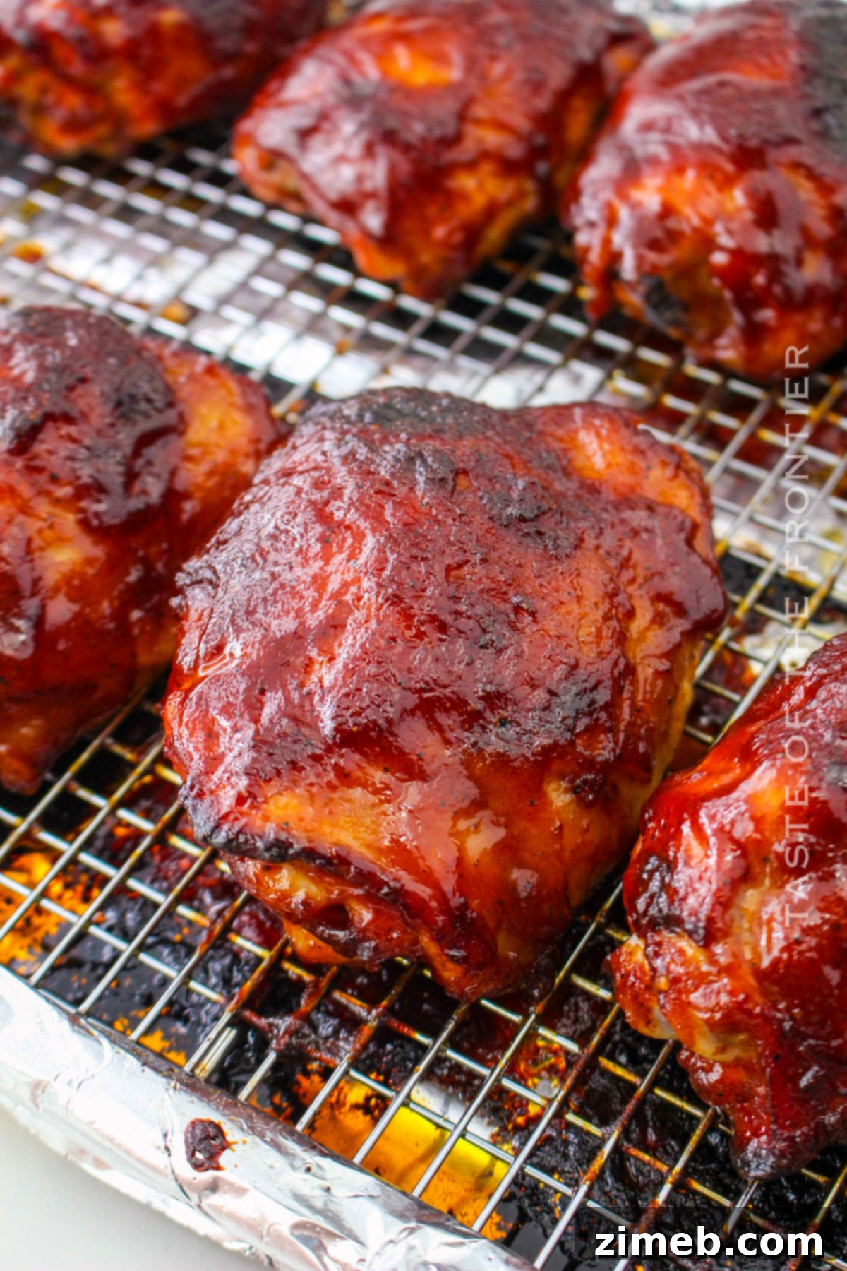Oven Baked BBQ Chicken Thighs 8 Golden brown BBQ baked chicken thighs, fresh from the oven, ready to be served.