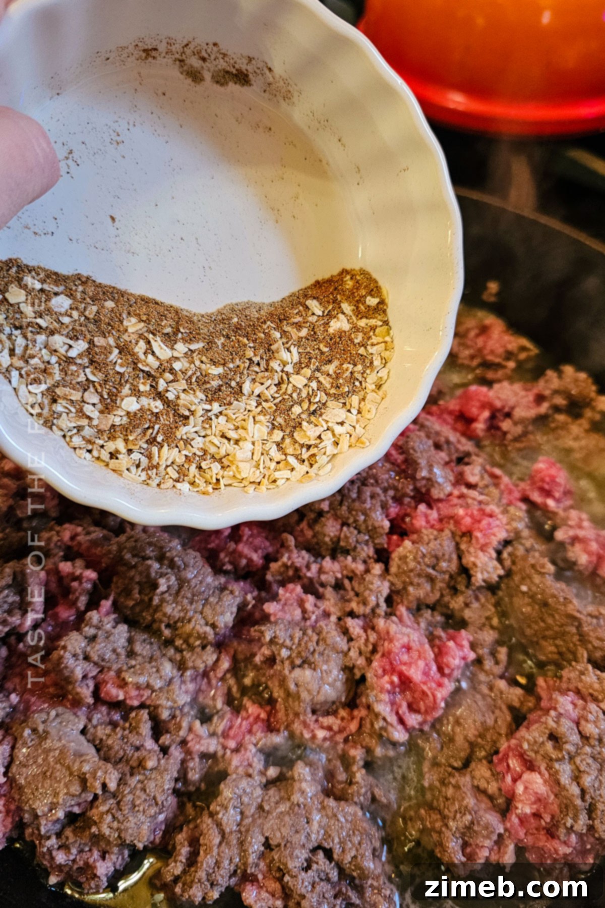 Flavorful Taco Filling 7 Adding the spices to the ground beef in the skillet for taco meat.
