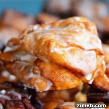 Stack of homemade apple fritters, drizzled with glaze