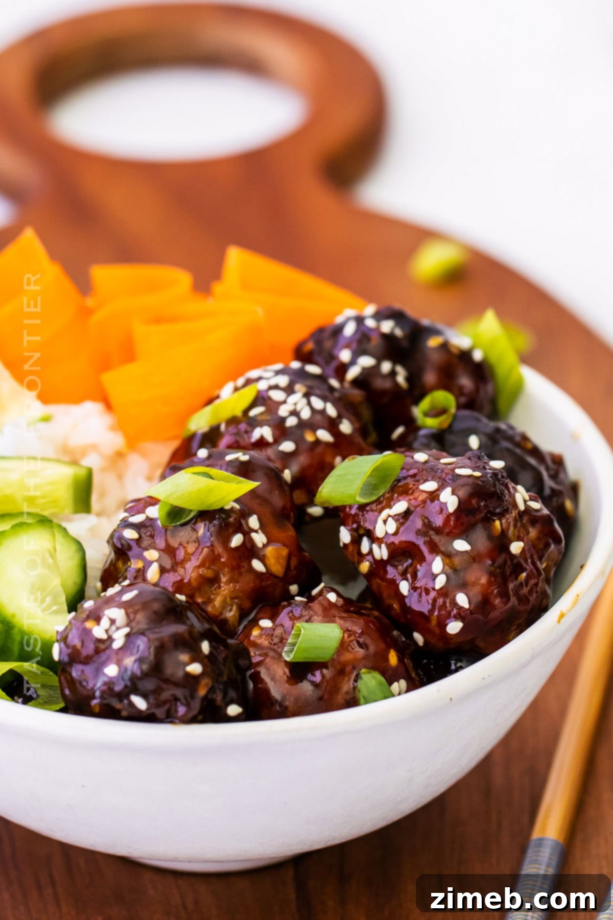 Sticky Asian Pork Meatballs 2 Succulent Asian Pork Meatballs, glazed with sesame ginger sauce, served as a main dish with rice.