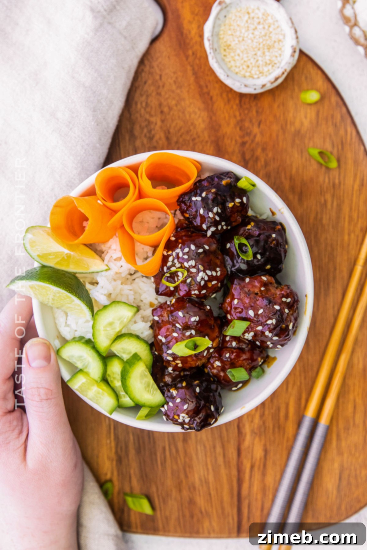 Sticky Asian Pork Meatballs 7 A beautifully plated Asian Pork Meatball dinner, highlighting the glossy sauce and garnishes.