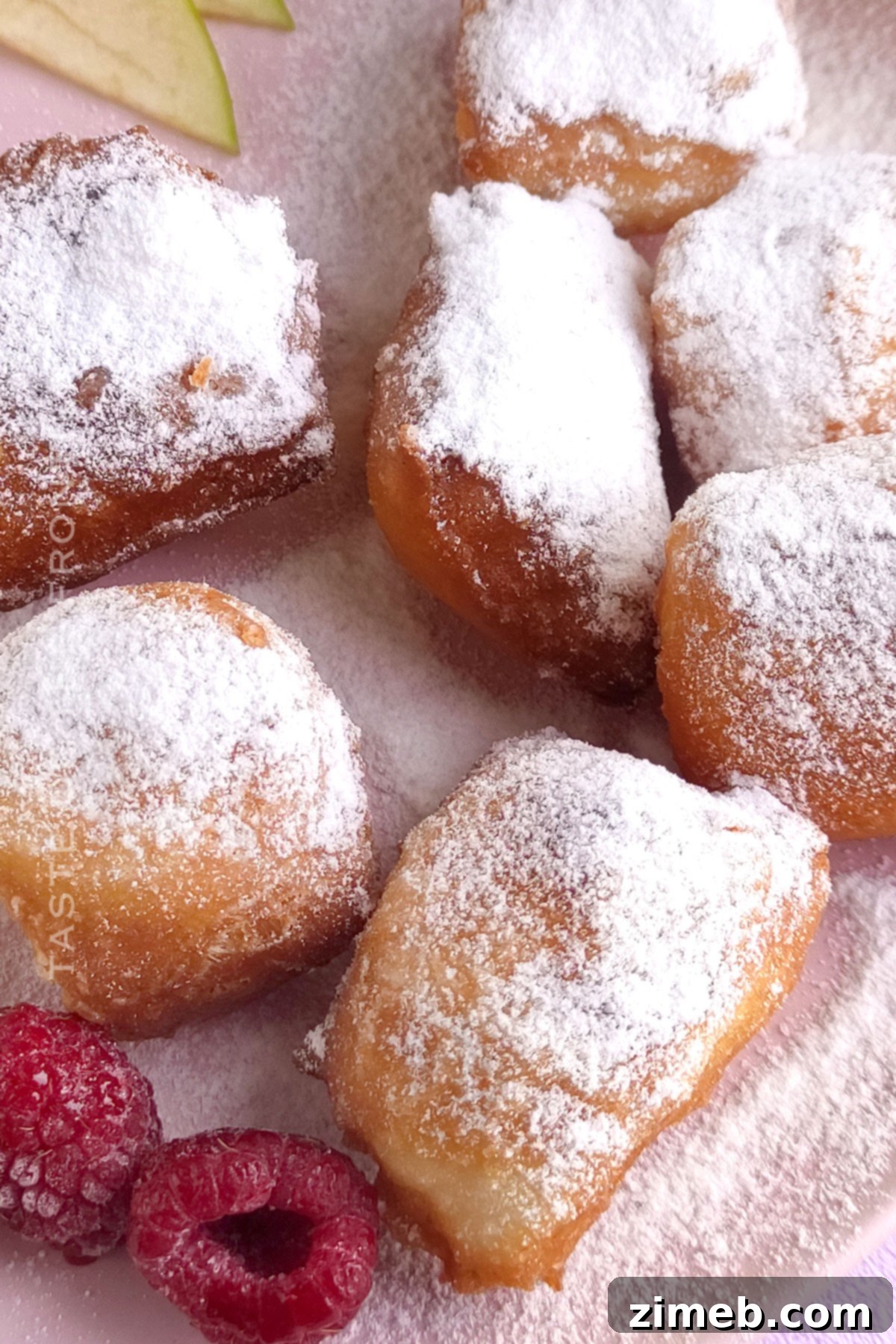 Fluffy New Orleans Beignets 3 French donut squares piled high with powdered sugar