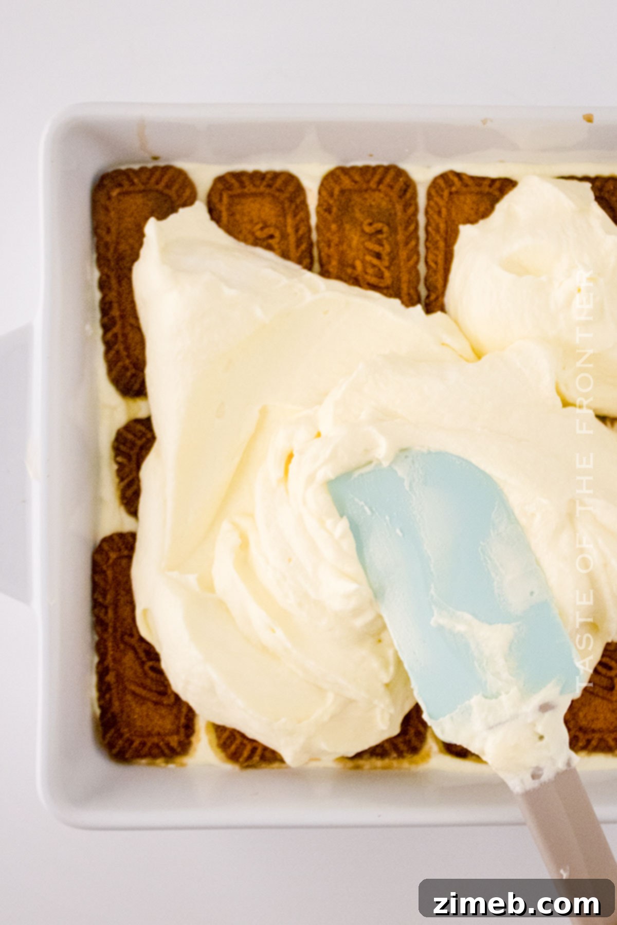 Spiced Biscoff Tiramisu 6 Layering the Biscoff Tiramisu with cream and cookies in a clear dish