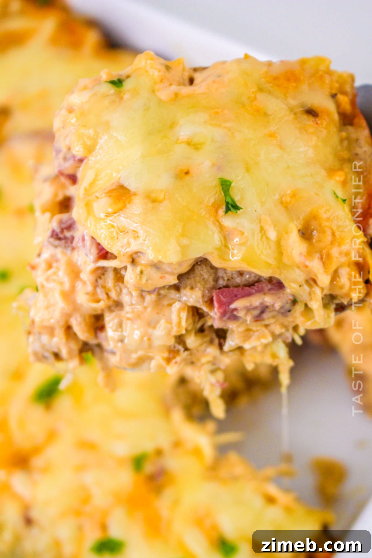 St. Patrick's Day Casserole - Layers of corned beef, sauerkraut, Swiss cheese, and zesty Russian dressing make this Reuben Casserole perfect for celebrations.