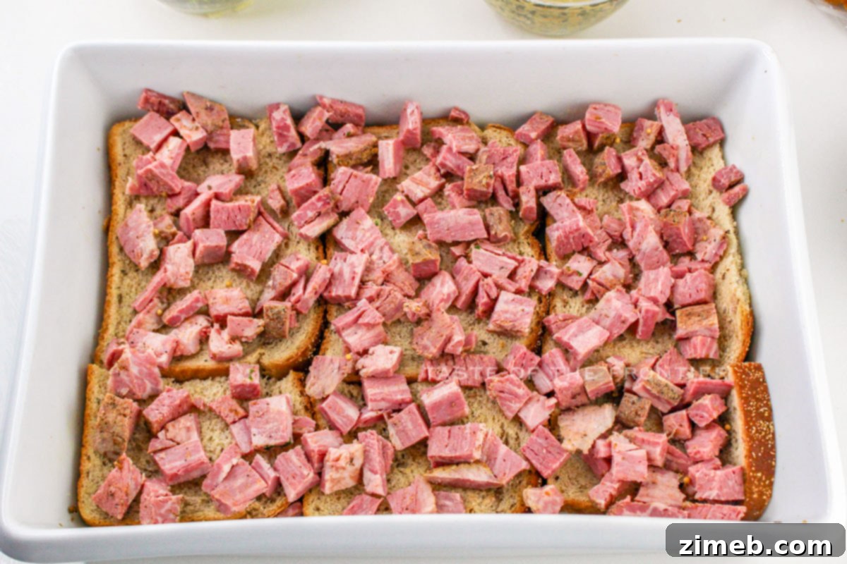 Assembling the Reuben Casserole - Layers of delicious ingredients being carefully placed in the baking dish.
