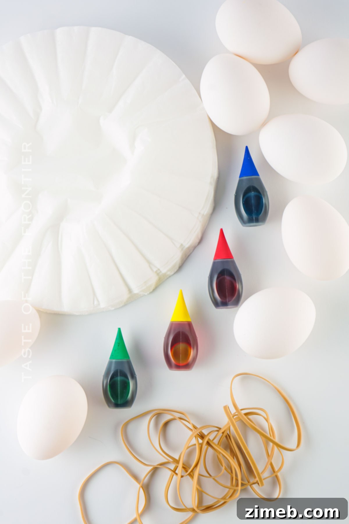 Kaleidoscope Easter Eggs 4 Ingredients for Tie-Dyed Easter Eggs including food coloring, coffee filters, and rubber bands