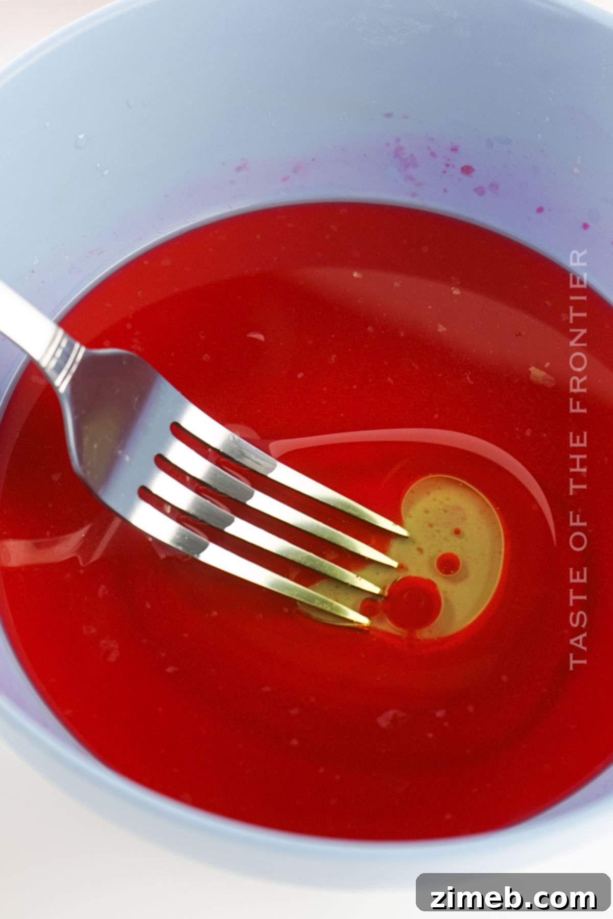Veined Stone Orbs 6 Mixing oil and food coloring in a bowl for marble eggs