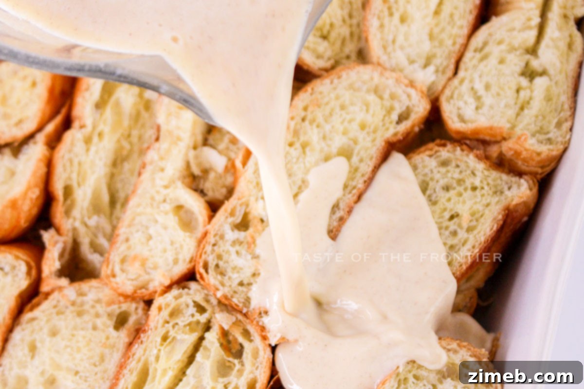 A bowl of creamy custard mixture, ready to be poured over croissants.