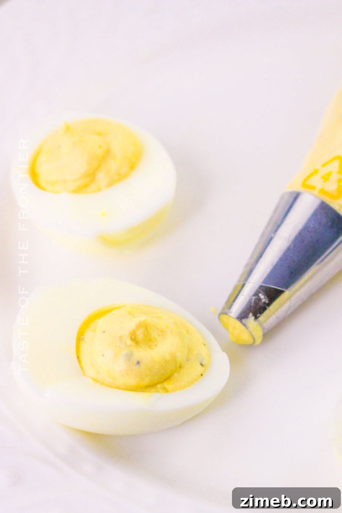 Decadent Deviled Eggs 14 Piping the filling into deviled eggs