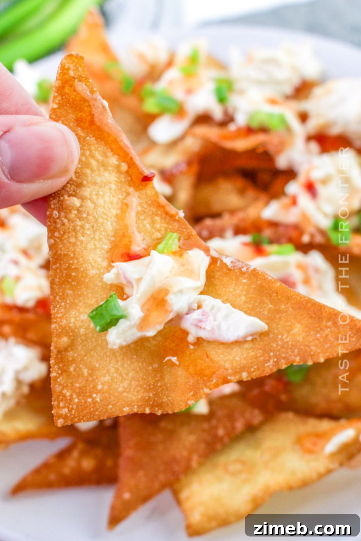 Crispy Rangoon Crab Nachos 2 Crab Rangoon Nachos piled high on a platter