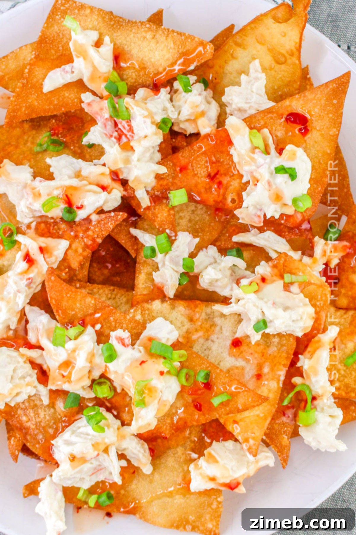 Crispy Rangoon Crab Nachos 3 Close-up of a crab appetizer with fresh green onions