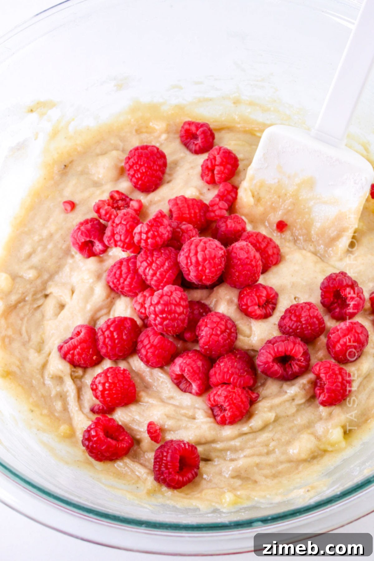 Adding fresh raspberries to muffin batter