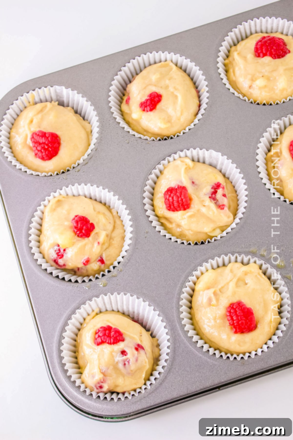 Baked Banana Raspberry Muffins cooling on a rack