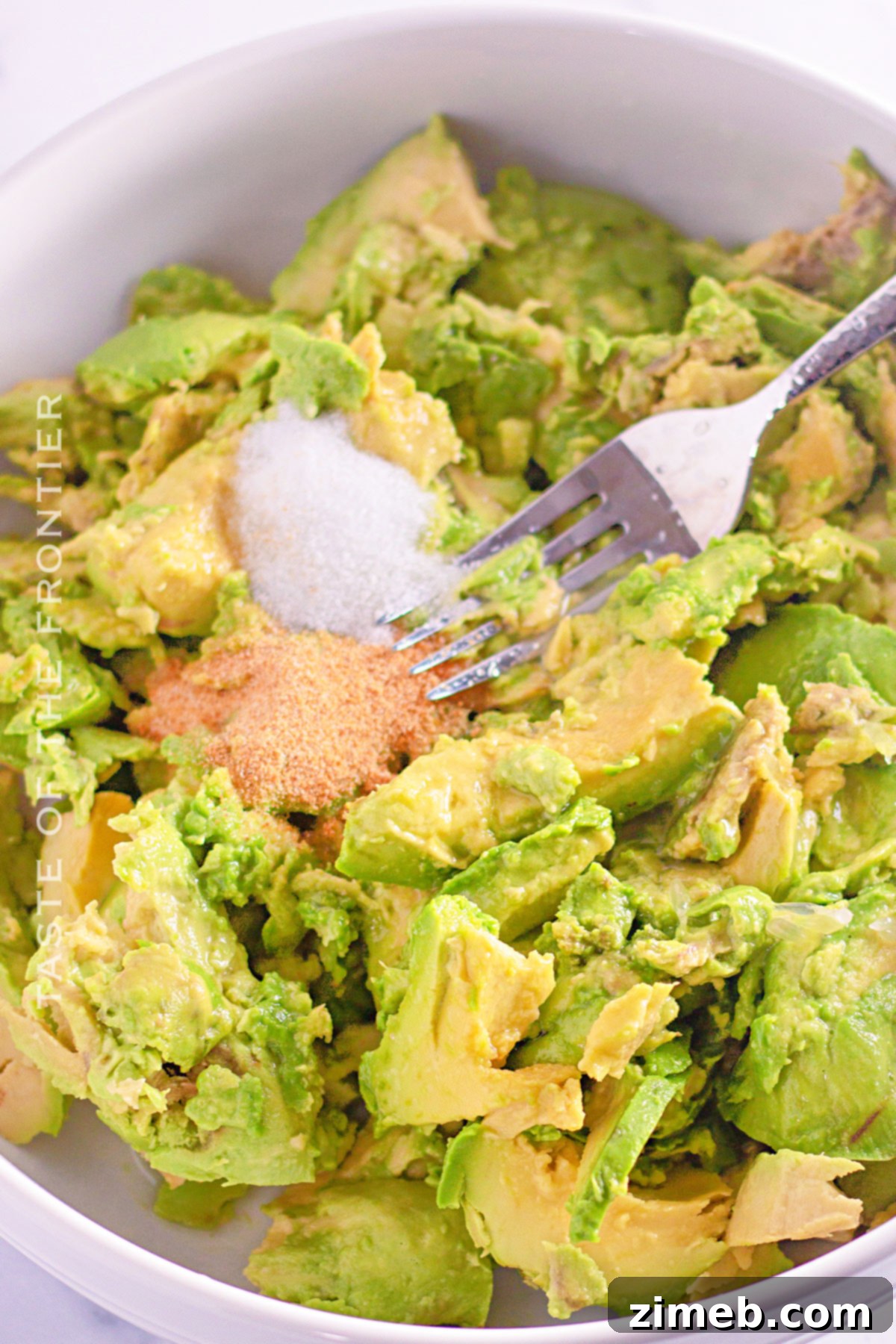 Ultimate Creamy Guacamole 5 mixing all the ingredients
