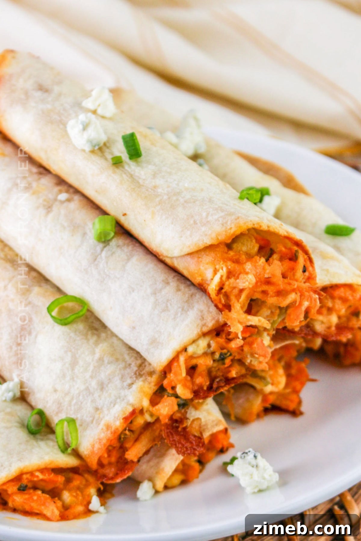 Crispy Buffalo Chicken Taquitos 2 Crispy Buffalo Chicken Taquitos, golden brown and ready to serve