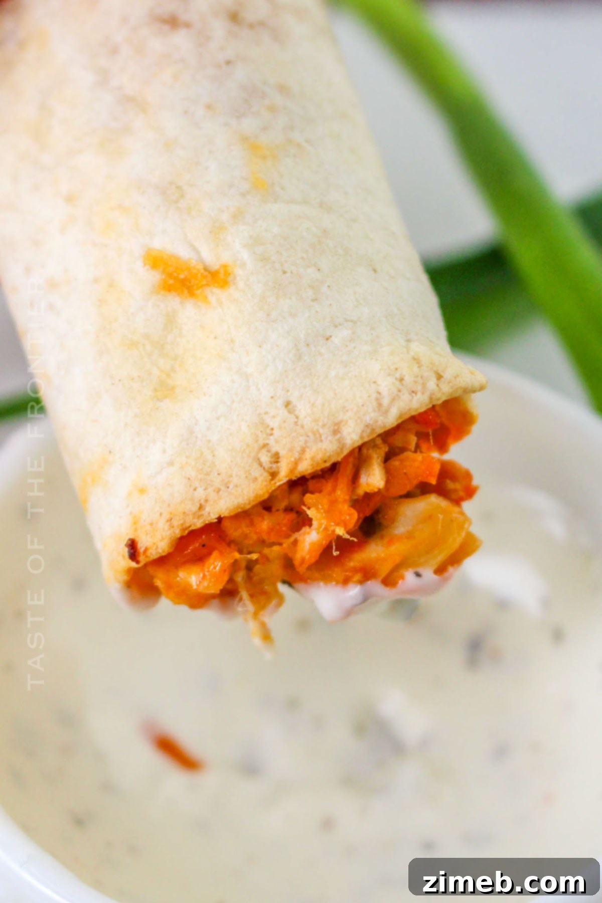 Crispy Buffalo Chicken Taquitos 3 A plate of freshly made Buffalo Chicken Taquitos with dipping sauce