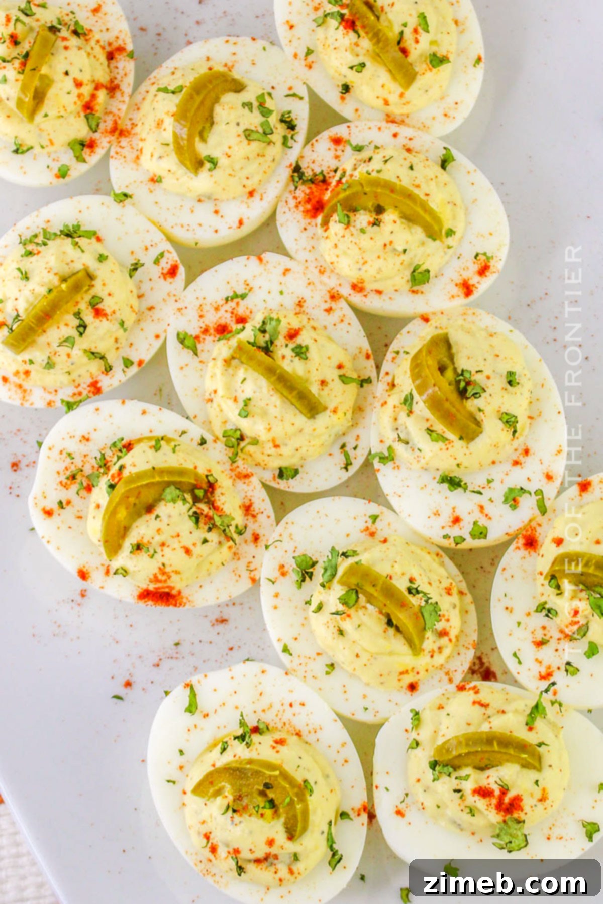 Zesty Jalapeño Deviled Eggs 13 An appetizer spread featuring Jalapeno Deviled Eggs alongside other party foods, emphasizing their role as a vibrant, spicy option.