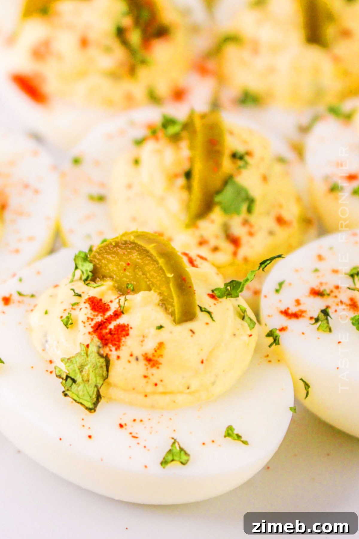 Zesty Jalapeño Deviled Eggs 14 A large platter of beautifully arranged Jalapeno Deviled Eggs, showing off the creamy filling and spicy garnishes, ready for serving.