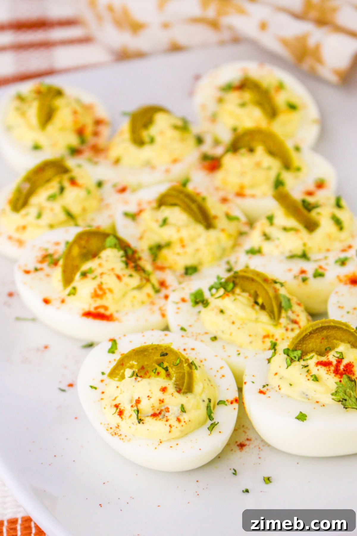 Zesty Jalapeño Deviled Eggs 3 Close-up of creamy egg filling mixed with finely diced jalapenos in a bowl, ready to be piped into egg whites.