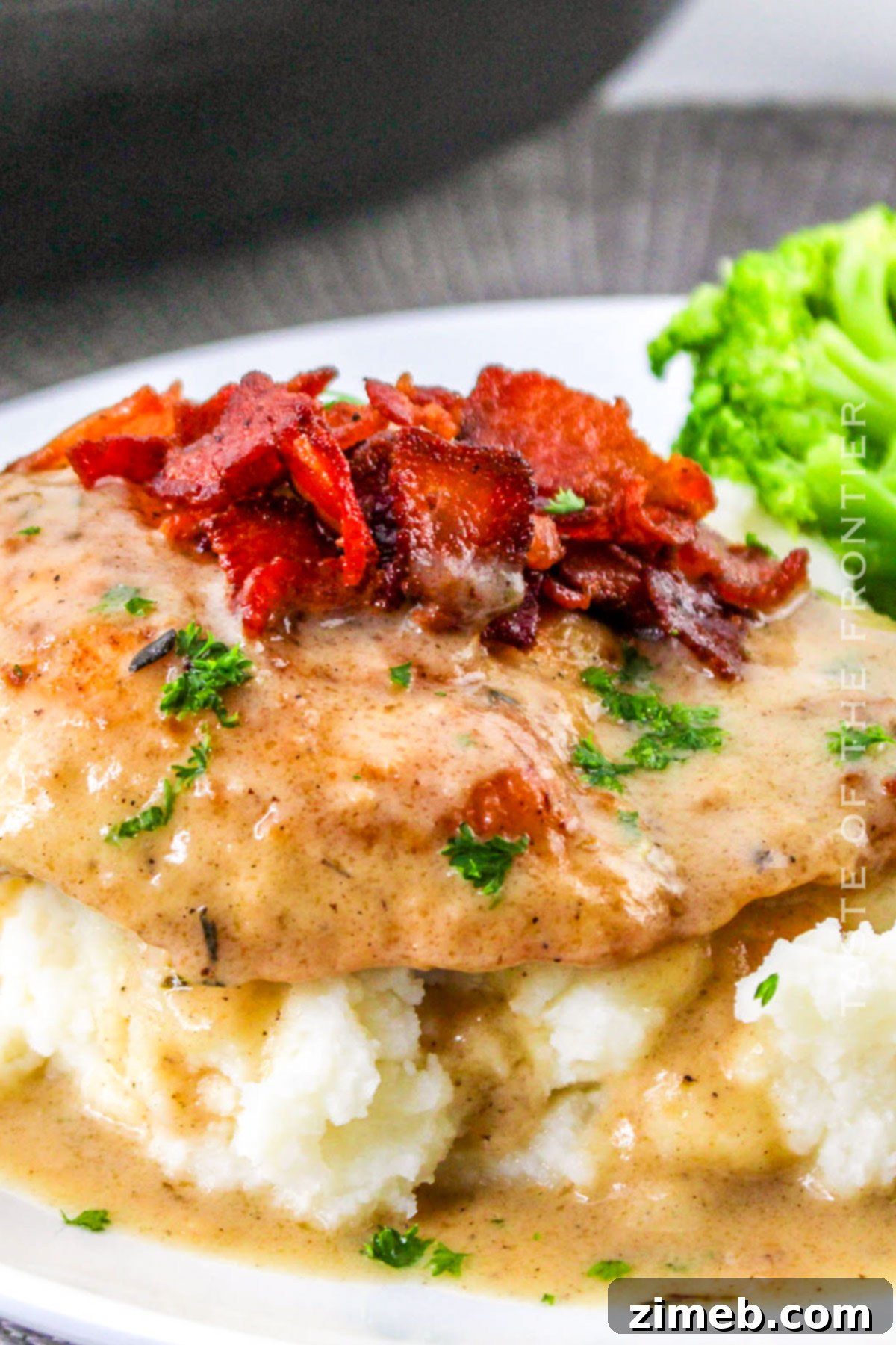 Smothered Chicken dinner served with mashed potatoes and green beans