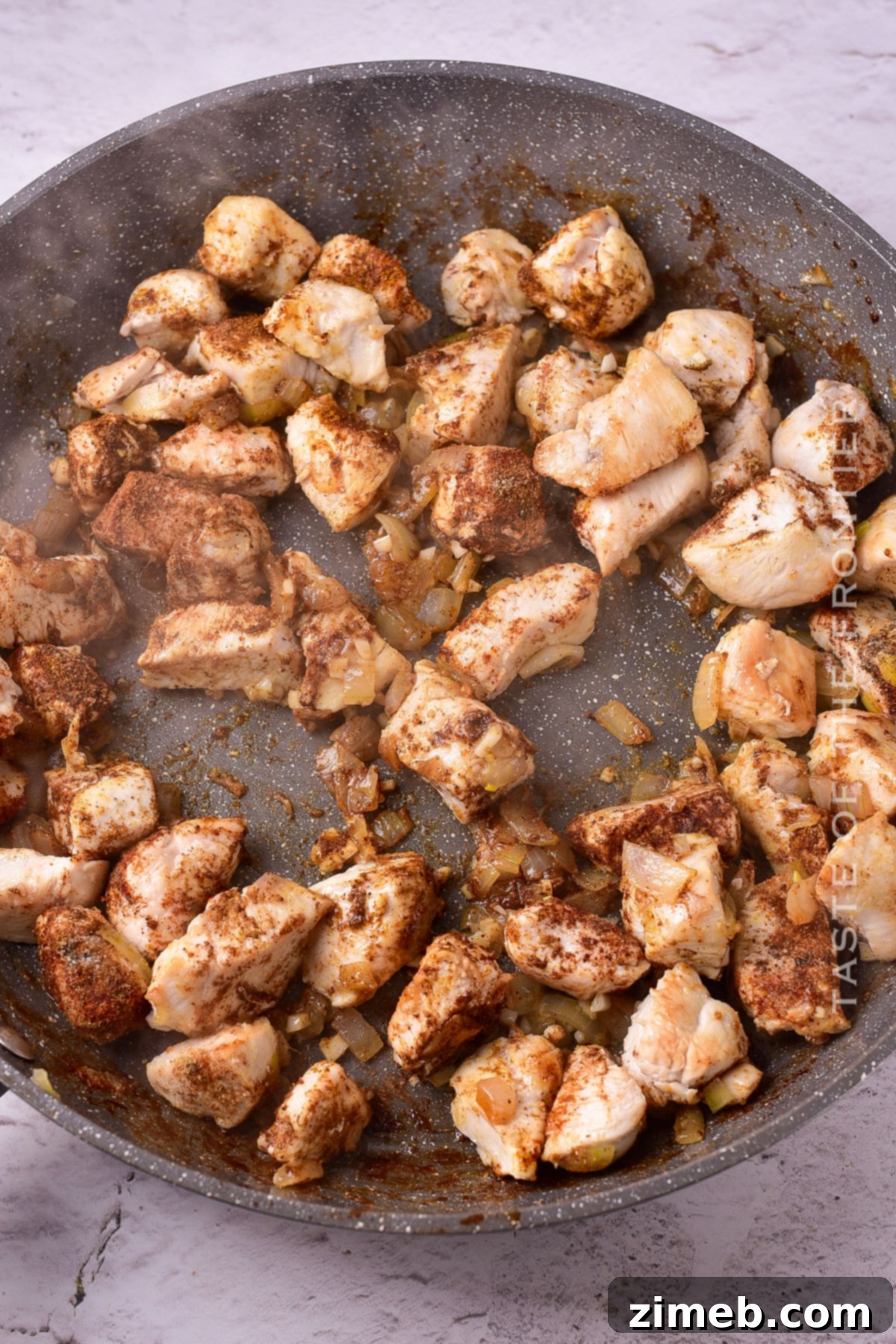 Cooking chicken on the stovetop for a delicious curry.