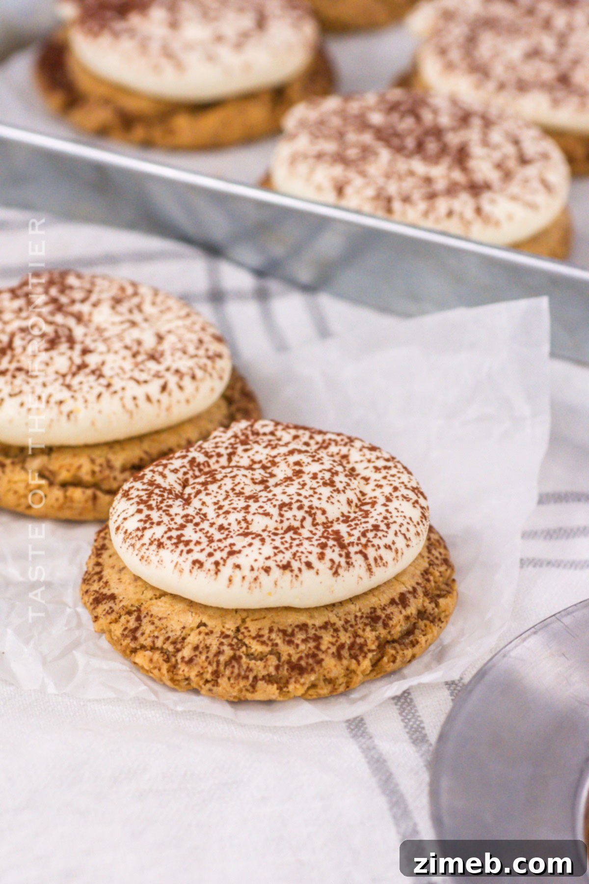 Espresso coffee cookie treat with mascarpone frosting and cocoa dusting.