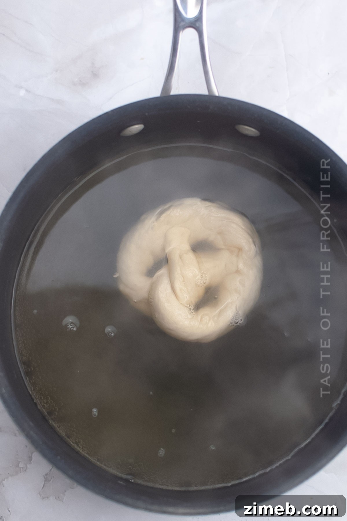 Artisan Sourdough Pretzels 7 Sourdough pretzel dough boiling in a baking soda water bath.