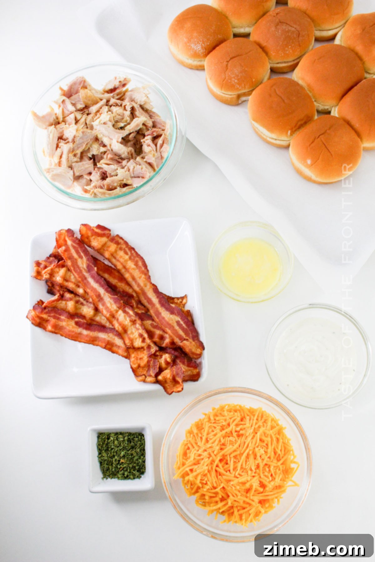 Ultimate Bacon Ranch Chicken Sliders 4 Bacon Chicken Ranch Slider ingredients - all ingredients laid out on a kitchen counter, including rolls, shredded chicken, bacon, cheese, ranch, and butter.