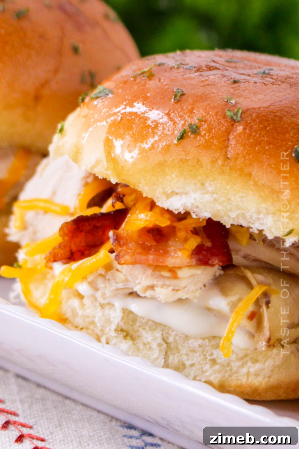 Ultimate Bacon Ranch Chicken Sliders 7 easy slider recipe with chicken - several sliders on a serving tray, ready to be picked up and enjoyed.