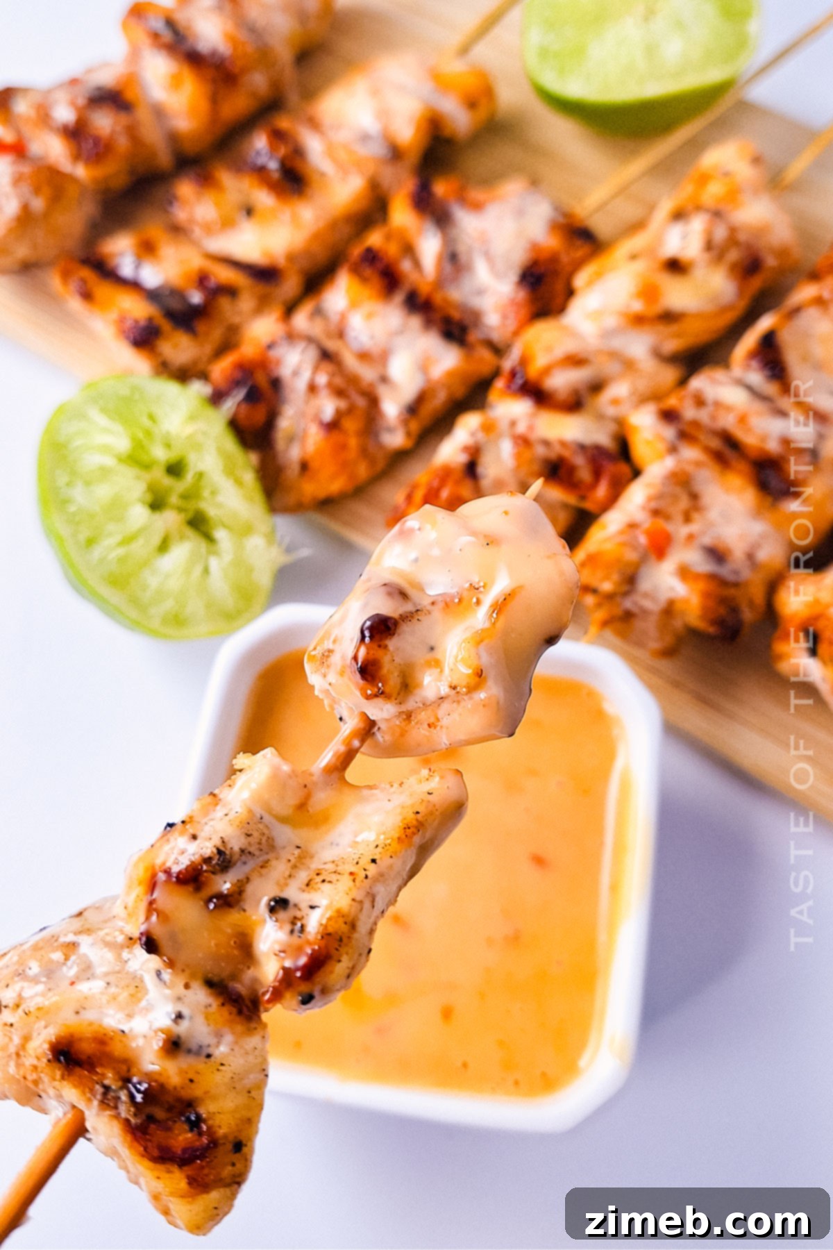 Chicken Skewers with Bang Bang Sauce 14 Perfectly grilled chicken kabobs, glistening with creamy sauce, arranged on a serving platter with fresh herbs.