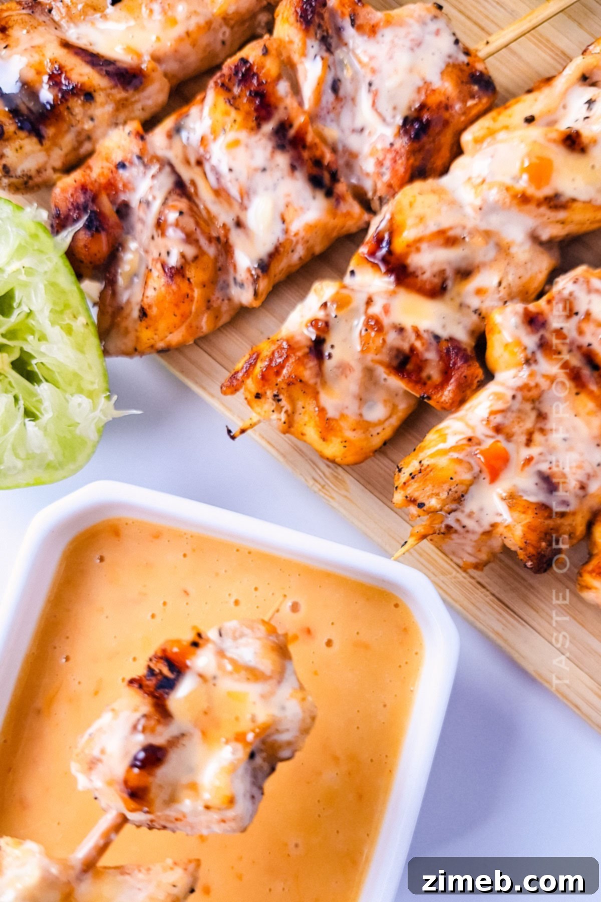 Chicken Skewers with Bang Bang Sauce 3 Saucy grilled chicken skewers with Bang Bang sauce, glistening and ready to serve on a platter.