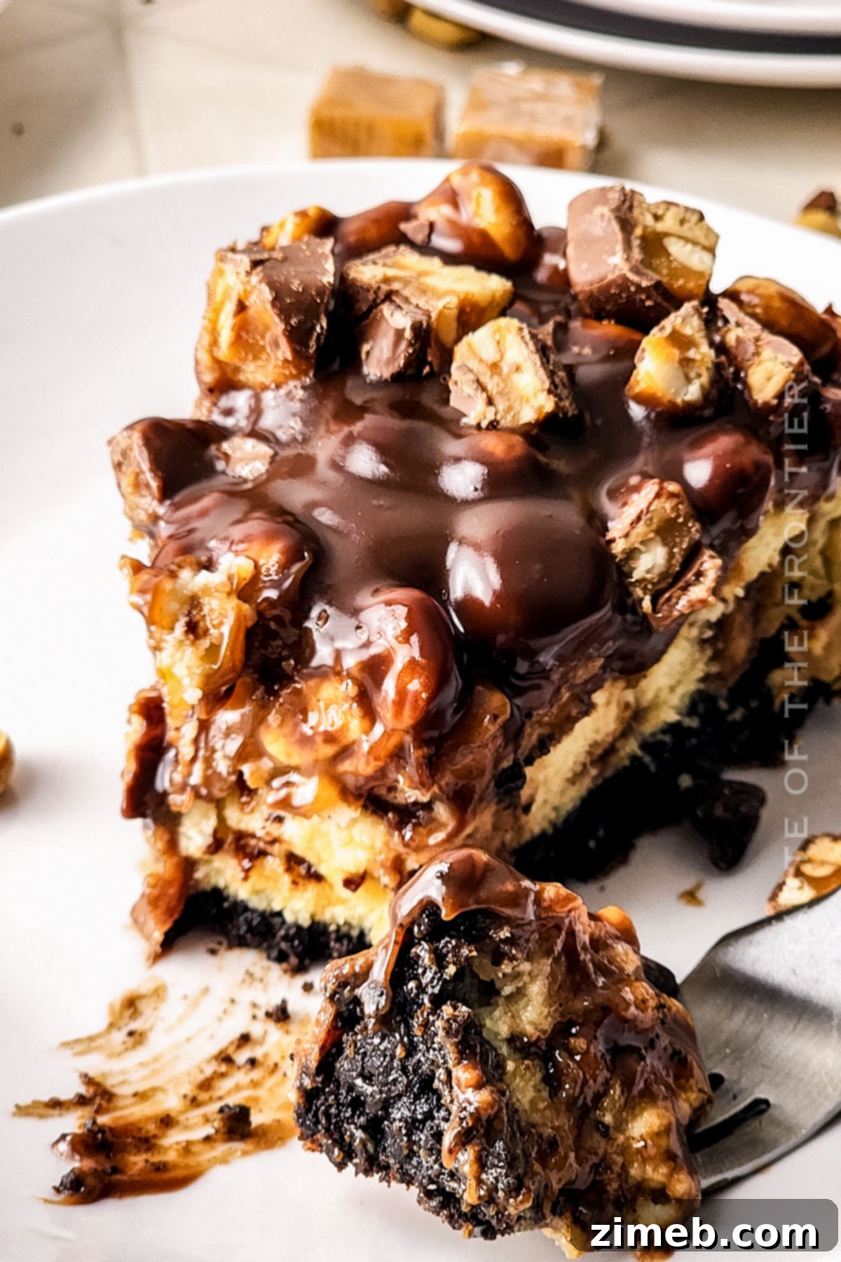 A beautifully decorated Snickers Cheesecake, showcasing all its delectable layers.