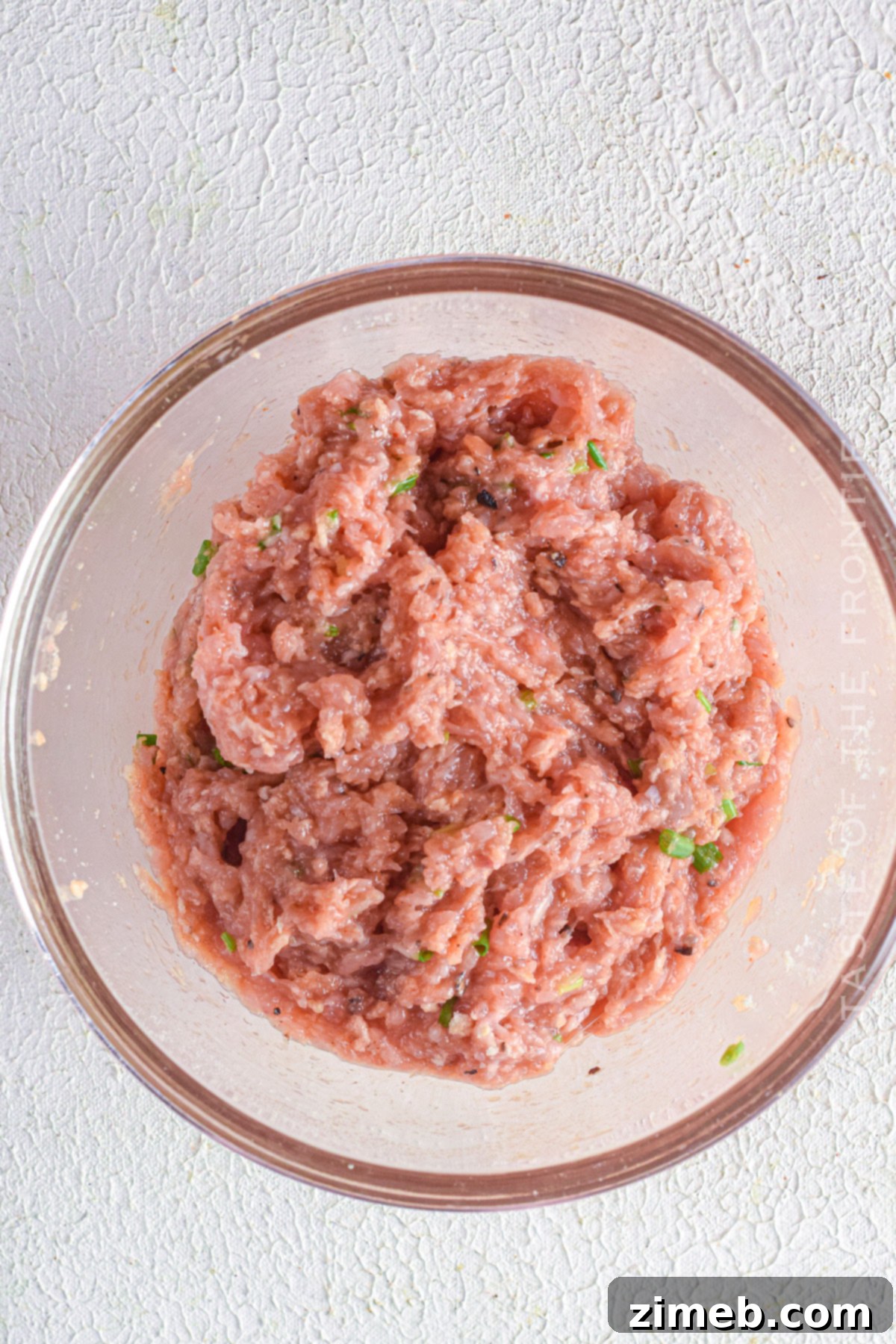 combining the ground chicken with seasonings