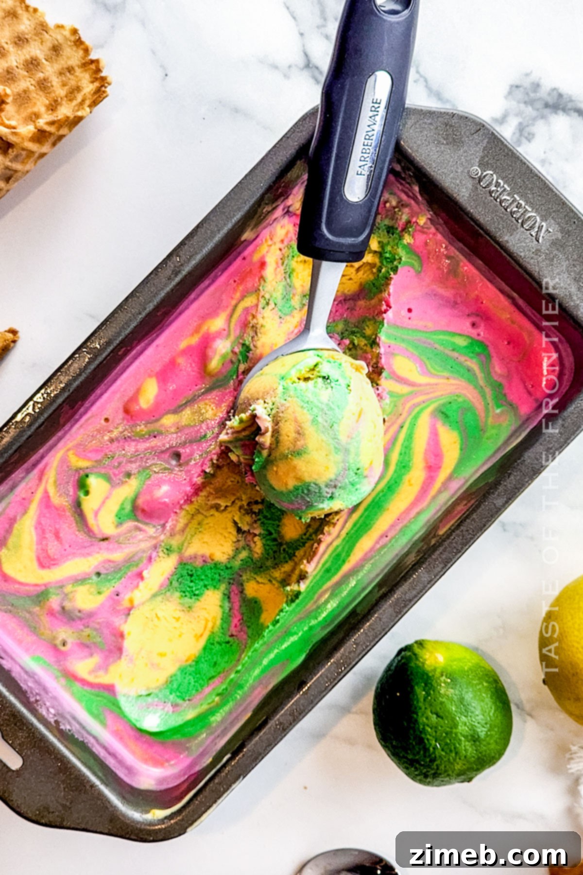 Fruity citrus rainbow sherbet scooped into a bowl