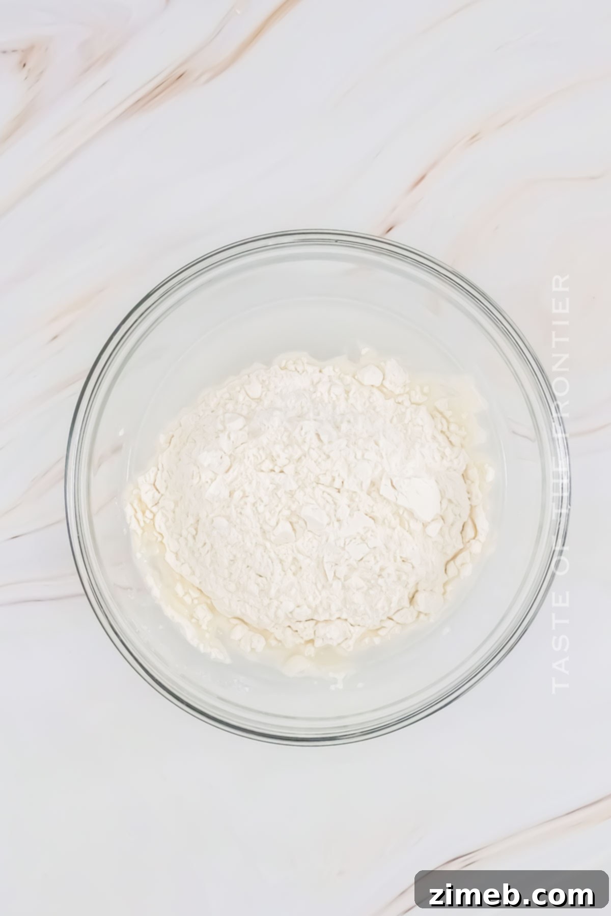 Bringing Your Sourdough to Life 4 Step 1: Mixing flour and water in a glass jar to begin a sourdough starter.