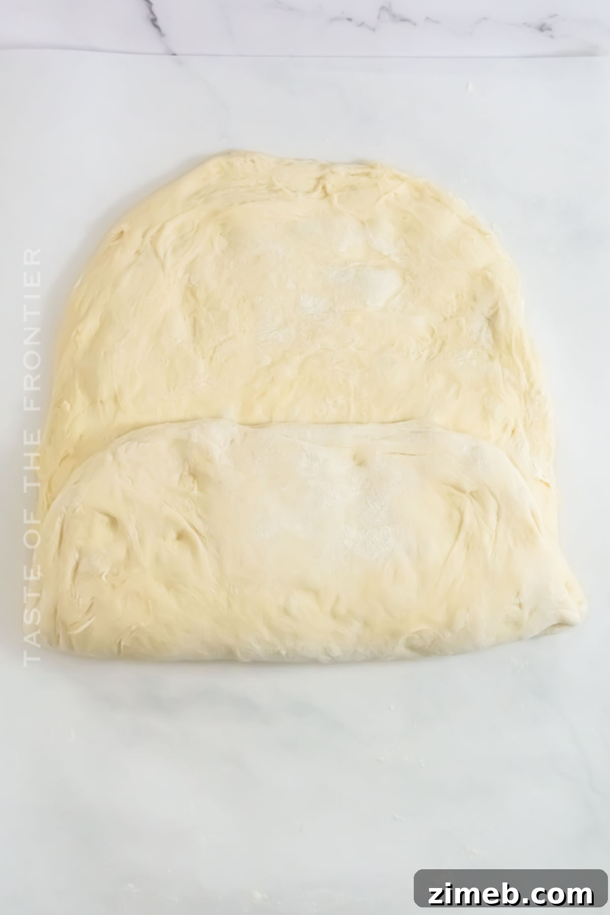 Bake Your Own Sourdough Masterpiece 6 Baker gently folding sourdough dough in a bowl, developing gluten for a perfect rise.