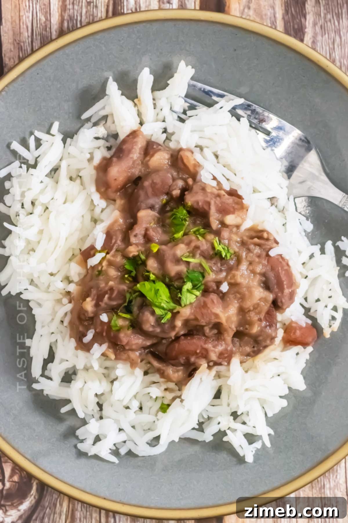 Classic Crockpot Red Beans & Rice simmering in a slow cooker, ready to be served over white rice for a cozy dinner.