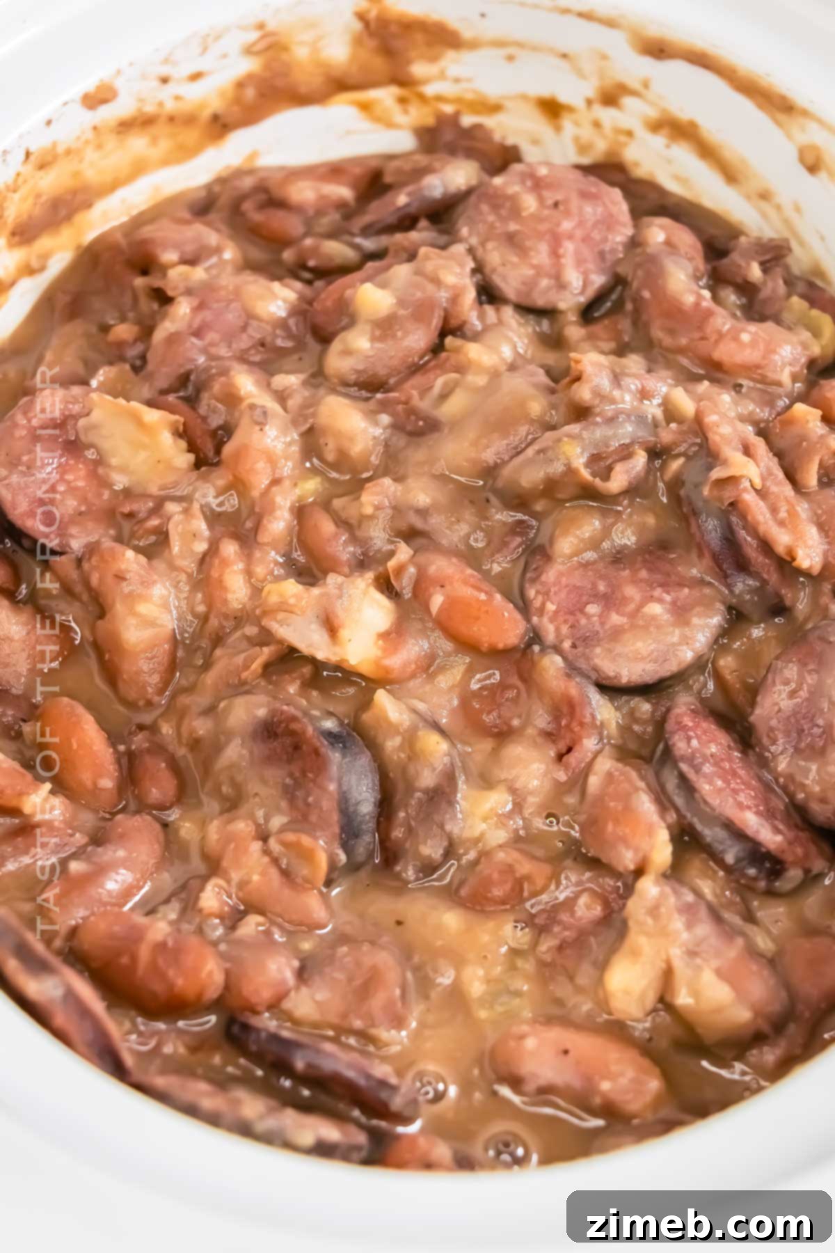 Final plated dish of Crockpot Red Beans & Rice, garnished with fresh herbs, showcasing the rich colors and textures.