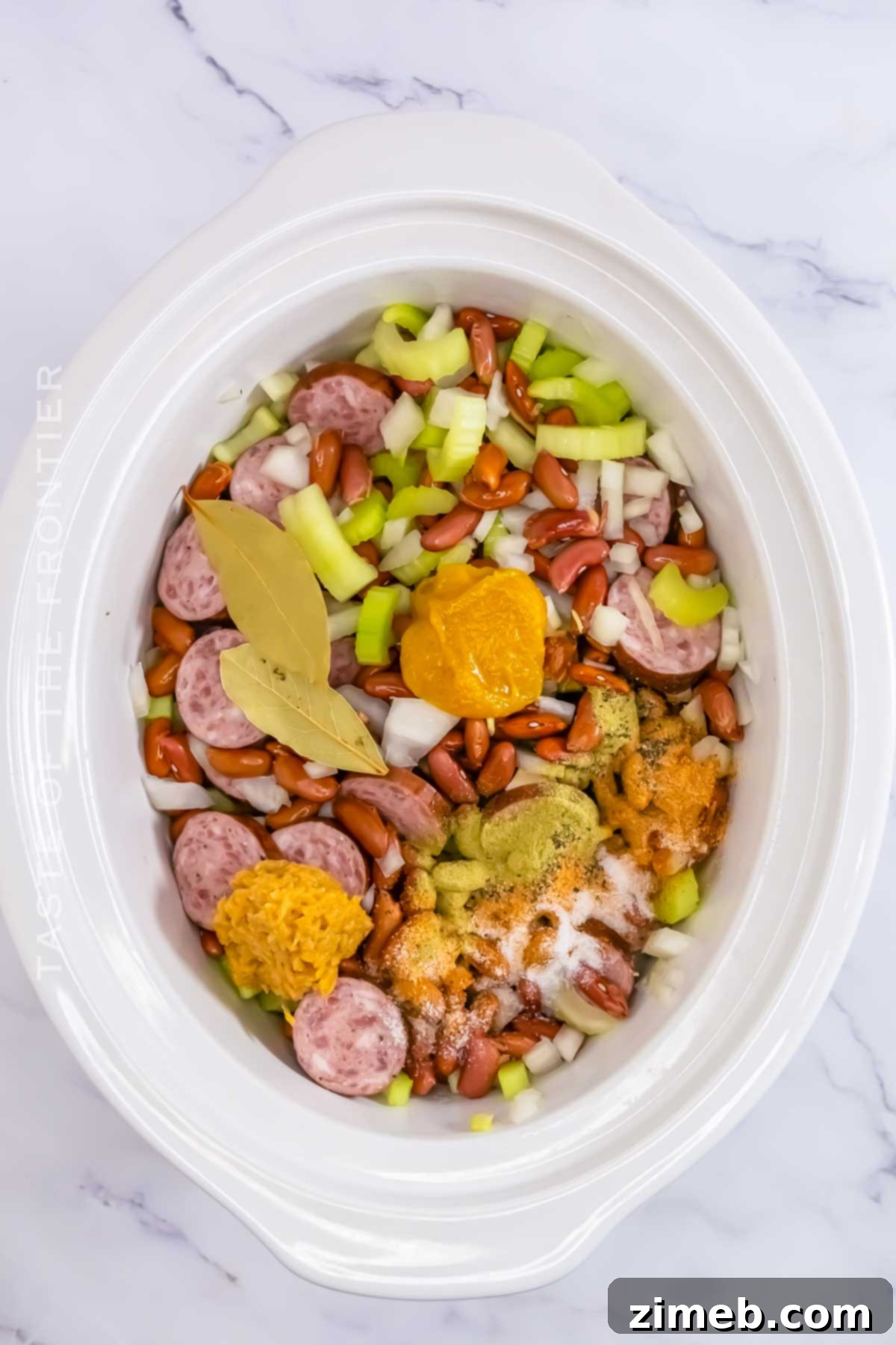 Step-by-step image of ingredients being added to a slow cooker for Red Beans & Rice.