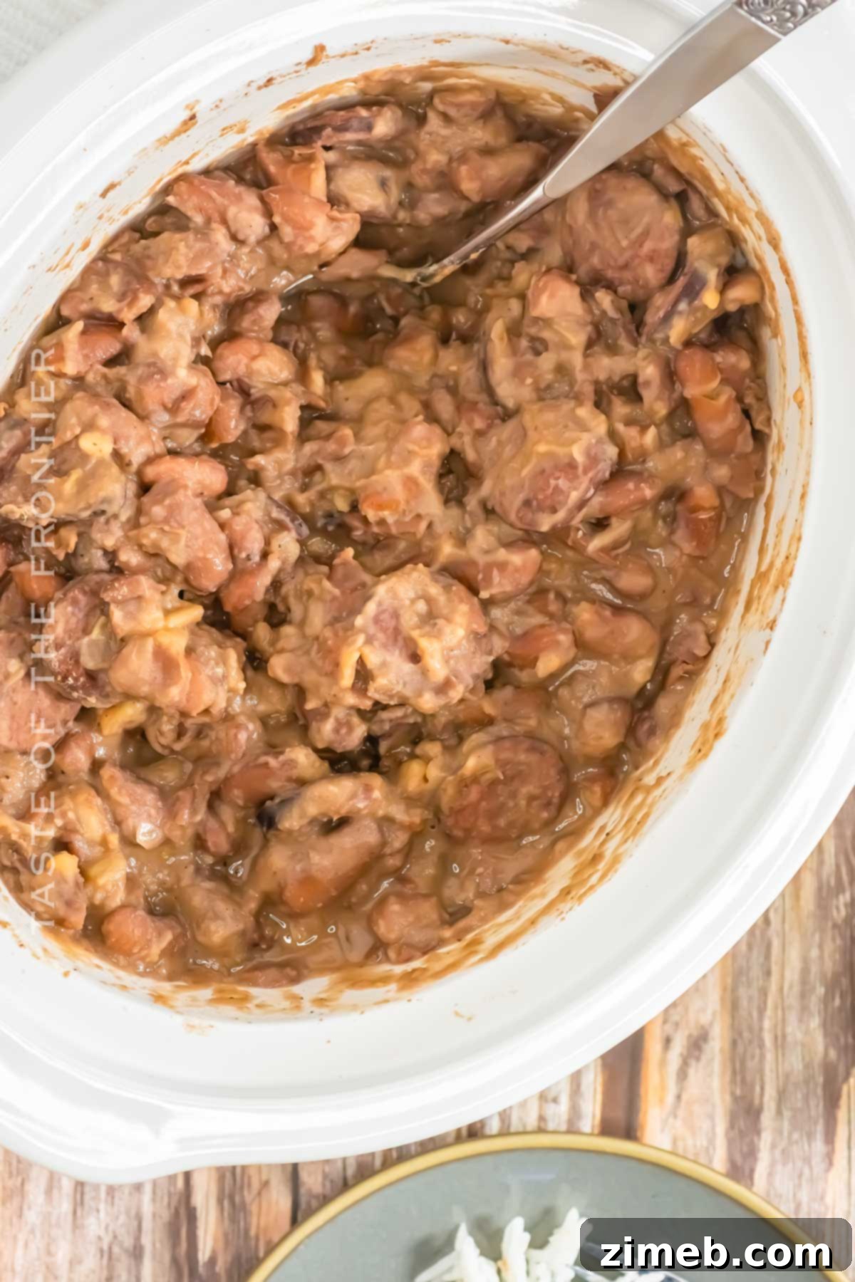 A large pot of Crockpot Red Beans & Rice with Andouille sausage and beans, ready to be served.