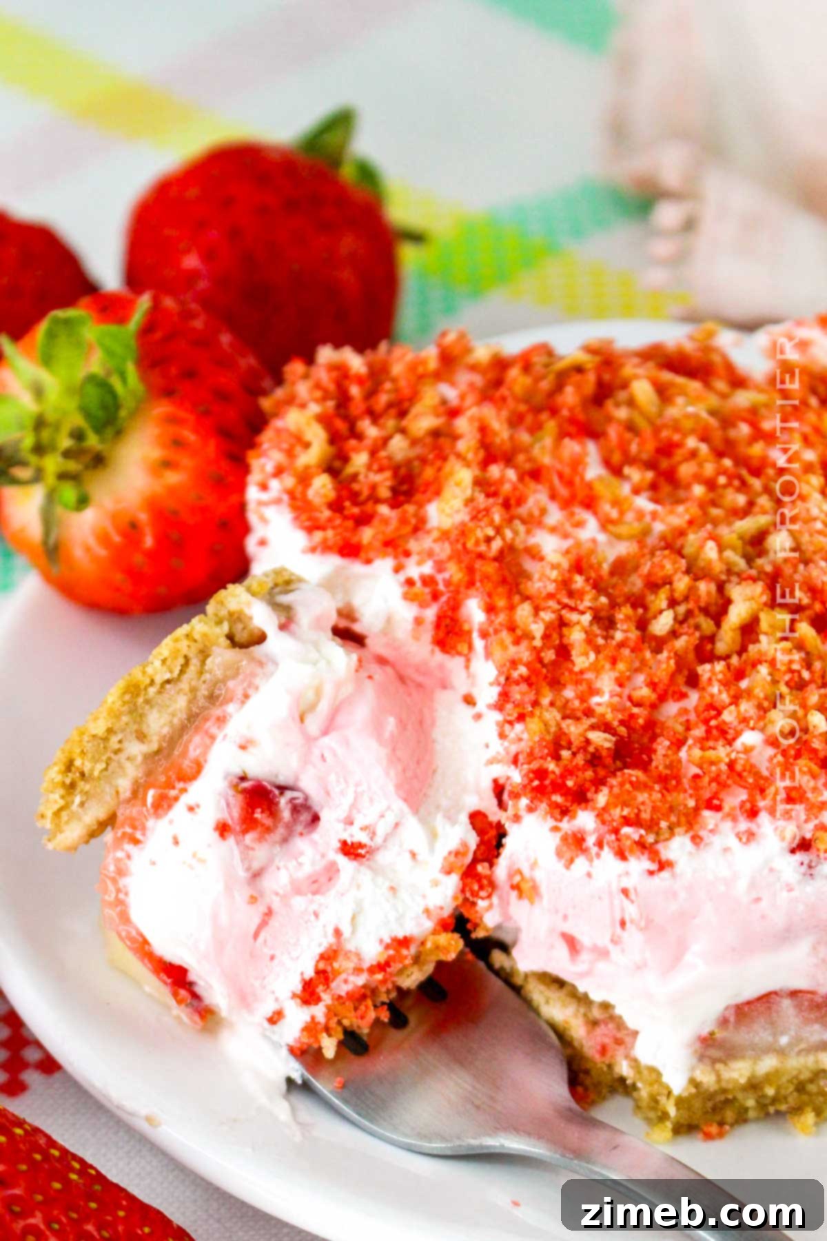 Crimson Indulgence 2 Beautifully layered No-Bake Strawberry Delight dessert, showcasing creamy filling, fresh strawberries, and a crunchy graham cracker crust, perfect for summer.