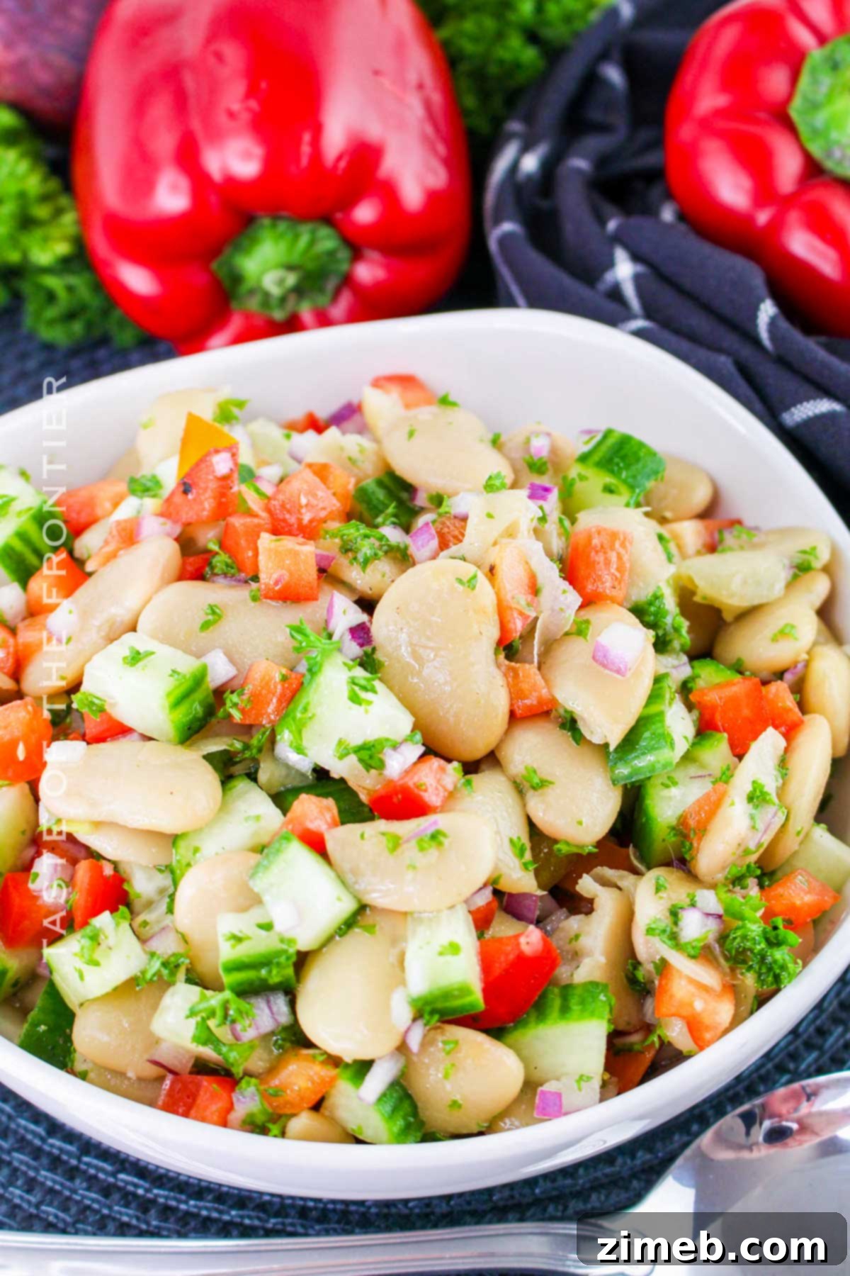 Overhead view of a finished Butter Bean Salad with fresh herbs.