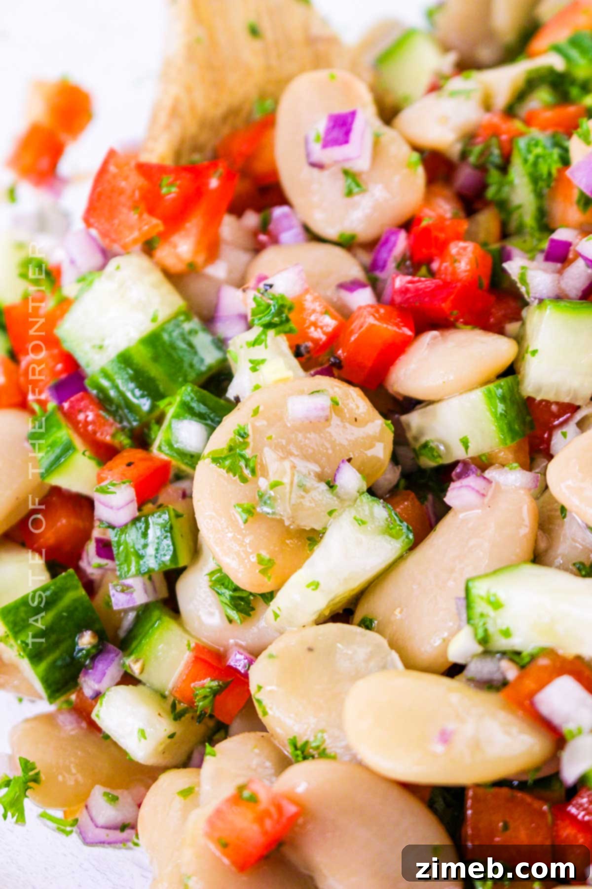 Butter Bean Salad arranged beautifully on a plate, ready for a potluck gathering.
