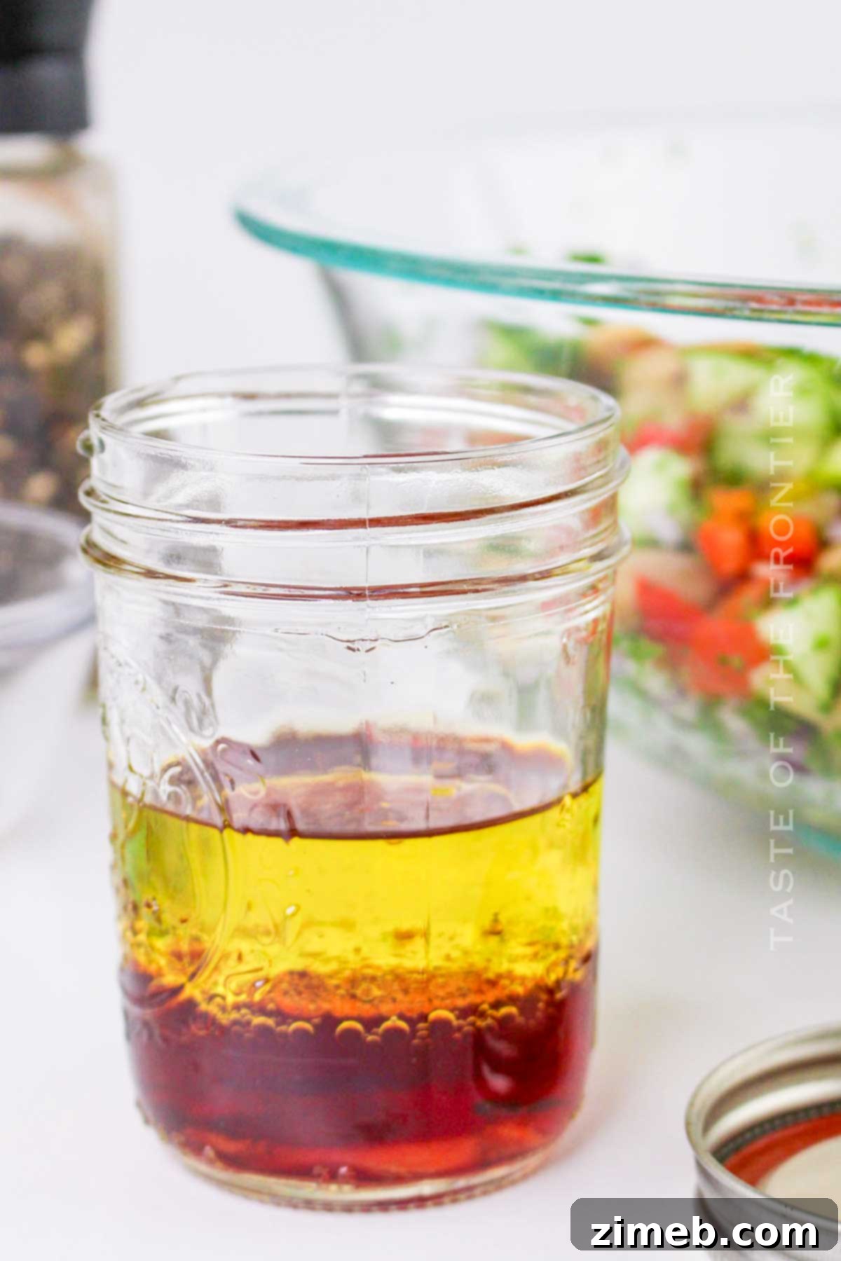 Whisking olive oil and red wine vinegar to create the zesty dressing for the Butter Bean Salad.
