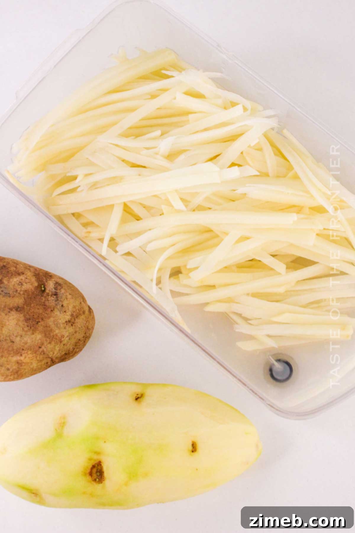 Slicing Russet potatoes into thin strips for fries